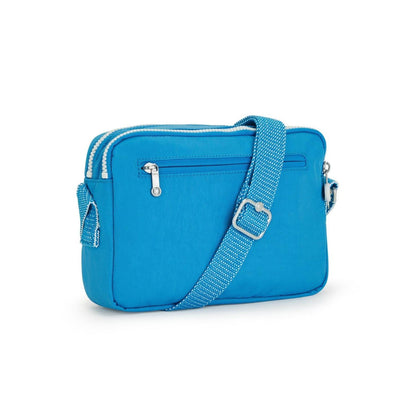 Kipling Abanu mini crossbody bag in Eager Blue with adjustable patterned strap and silver zippered compartments.