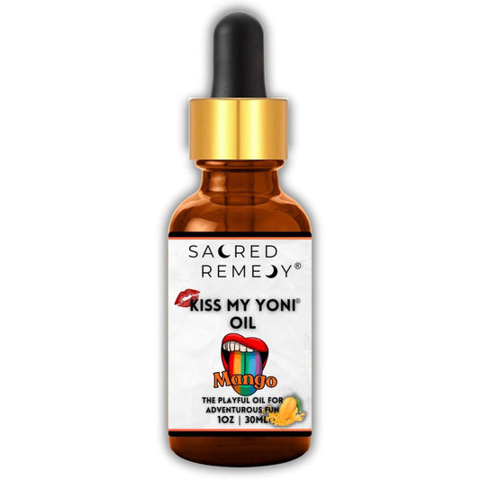 Amber glass dropper bottle of Kiss My Yoni Mango oil with a gold cap and playful lip and rainbow graphic label.