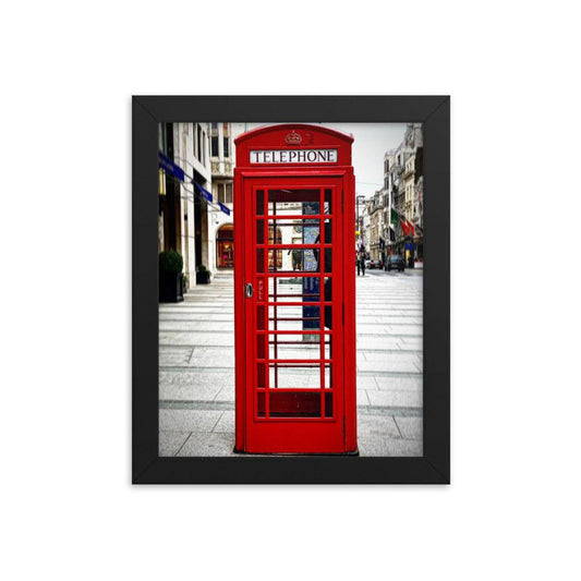 Vivid red London telephone booth poster in a sleek black frame, capturing a classic British street scene.