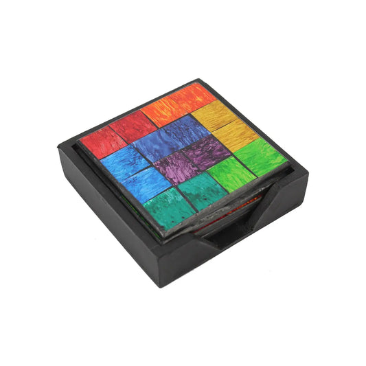 Handcrafted square mosaic coasters in vibrant rainbow colors, stored in a sleek black wooden holder.