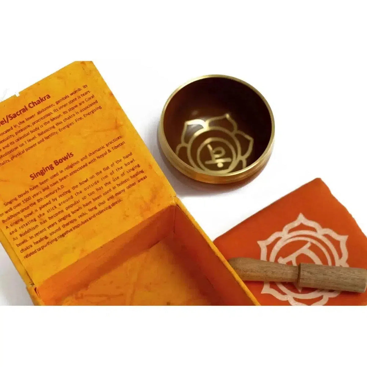 8cm brass Sacral Chakra singing bowl with engraved lotus symbol, wooden mallet, and orange gift box with informational text.