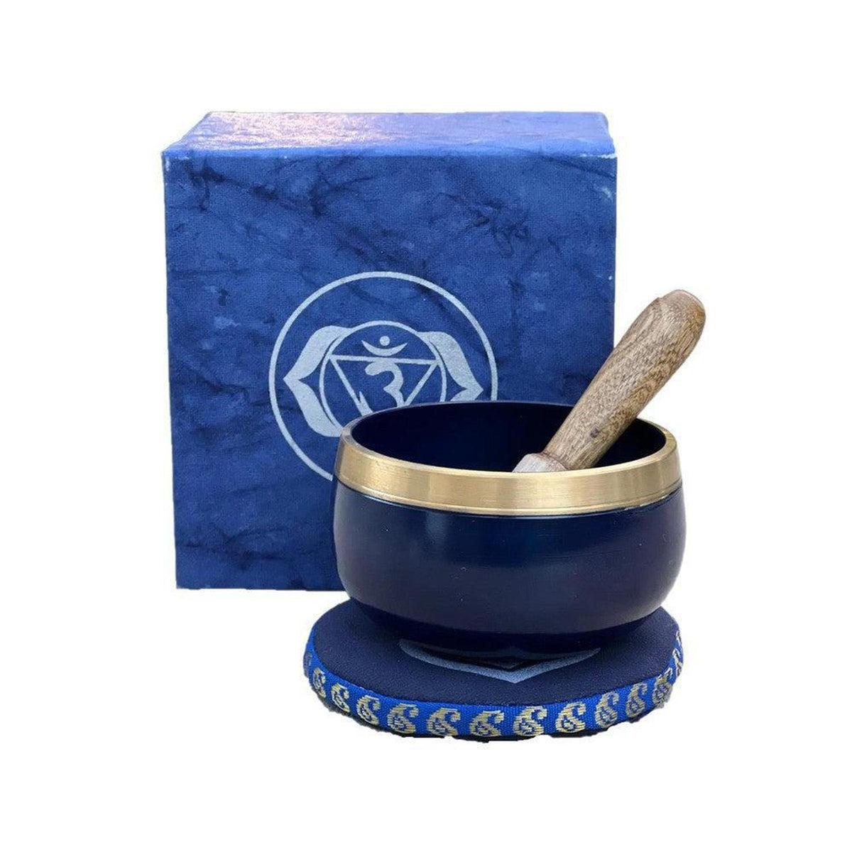 Midnight blue singing bowl with brass rim, wooden striker, and matching Third Eye chakra gift box on a blue cushion.