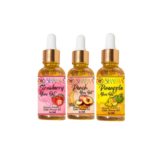 Three 30ml glass dropper bottles of strawberry, peach, and pineapple scented yoni oils with gold caps.